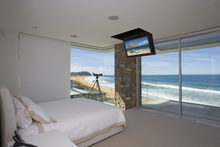 Spartan ceiling TV lift lowered in a coastal bedroom